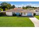 Charming single-story home with a well-maintained lawn, front yard landscaping, and attached garage at 7301 12Th W Ave, Bradenton, FL 34209