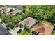 Aerial view of home, showing the roof, landscaping, driveway and nearby lake at 7439 Sea Island Ln, University Park, FL 34201