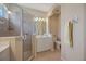 Bright bathroom features a glass enclosed shower, neutral tile, and a single sink vanity at 7439 Sea Island Ln, University Park, FL 34201