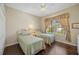 Cozy bedroom with hardwood floors, two twin beds and a window letting in plenty of natural light at 7439 Sea Island Ln, University Park, FL 34201
