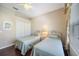 Comfortable bedroom features hardwood floors, two twin beds, and a closet for storage at 7439 Sea Island Ln, University Park, FL 34201
