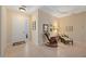 Inviting entryway featuring tile floors, neutral walls, wicker rocking chair and front door at 7439 Sea Island Ln, University Park, FL 34201