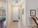 Inviting entryway featuring tile floors, neutral walls, and view to a bedroom through an open doorway at 7439 Sea Island Ln, University Park, FL 34201