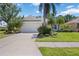 Inviting single-story home with a well-maintained lawn, mature landscaping, and a two-car garage at 7439 Sea Island Ln, University Park, FL 34201