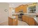 Bright kitchen with stainless steel appliances, granite countertops, island and natural wood cabinets at 7439 Sea Island Ln, University Park, FL 34201