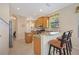 Open concept kitchen with granite countertops, stainless appliances, and breakfast bar at 7439 Sea Island Ln, University Park, FL 34201