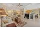 Bright living room features a tray ceiling, tile flooring, and an open layout to kitchen breakfast bar seating at 7439 Sea Island Ln, University Park, FL 34201
