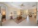 Spacious living room with tile floors, neutral paint, and tray ceiling that offers an open and airy feel at 7439 Sea Island Ln, University Park, FL 34201