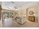 Bright living room with neutral colors features a tray ceiling and tiled floors at 7439 Sea Island Ln, University Park, FL 34201
