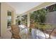 Relaxing screened-in patio with a table, chairs, and a grill overlooking the garden at 7439 Sea Island Ln, University Park, FL 34201