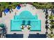 Overhead shot of a rectangular pool with spa, framed by palm trees and lounging areas at 7439 Sea Island Ln, University Park, FL 34201