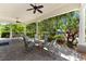A covered outdoor patio with ample seating and views of the lush landscaping at 7470 Botanica Pkwy # 201B22, Sarasota, FL 34238