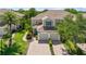 Lovely two-story home with a tile roof, arched entry, two-car garage, and mature landscaping at 7470 Botanica Pkwy # 201B22, Sarasota, FL 34238
