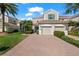 Charming townhouse with a brick driveway, manicured landscaping, and a two-car garage at 7470 Botanica Pkwy # 201B22, Sarasota, FL 34238