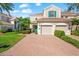 Charming townhouse with a brick driveway, manicured landscaping, and a two-car garage at 7470 Botanica Pkwy # 201B22, Sarasota, FL 34238