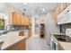 Kitchen featuring wooden cabinetry, tiled backsplash, and modern appliances at 7470 Botanica Pkwy # 201B22, Sarasota, FL 34238
