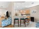 Kitchen area with bar seating, stainless appliances, and a view of the living room at 7470 Botanica Pkwy # 201B22, Sarasota, FL 34238