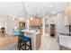 Bright kitchen open to living area, wooden cabinets, bar seating, and modern appliances at 7470 Botanica Pkwy # 201B22, Sarasota, FL 34238