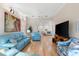 Inviting living room with light blue furniture, hardwood floors, and open layout at 7470 Botanica Pkwy # 201B22, Sarasota, FL 34238