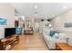 Spacious living room with hardwood floors, neutral colors, and comfortable seating arrangement at 7470 Botanica Pkwy # 201B22, Sarasota, FL 34238