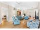 Bright and spacious living room featuring hardwood floors, recessed lighting, and stylish, comfortable seating at 7470 Botanica Pkwy # 201B22, Sarasota, FL 34238