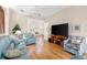 Bright and spacious living room featuring hardwood floors, recessed lighting, and stylish, comfortable seating at 7470 Botanica Pkwy # 201B22, Sarasota, FL 34238