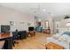 Open concept living room features hardwood floors and comfortable furniture and ample lighting at 7470 Botanica Pkwy # 201B22, Sarasota, FL 34238