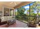 Inviting screened-in patio with comfortable seating and serene views of the surrounding greenery at 7470 Botanica Pkwy # 201B22, Sarasota, FL 34238