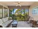 Inviting screened-in patio with comfortable seating and serene views of the surrounding greenery at 7470 Botanica Pkwy # 201B22, Sarasota, FL 34238