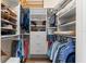 Organized walk-in closet featuring multiple shelves, drawers, rods, and ample storage space at 7470 Botanica Pkwy # 201B22, Sarasota, FL 34238