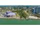 An aerial view of the Sarasota coastline with a highlighted waterfront condo in the background at 750 N Tamiami Trl # 304, Sarasota, FL 34236