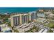 Stunning aerial view of high-rise condos with waterfront views, parking, and meticulous landscaping at 750 N Tamiami Trl # 304, Sarasota, FL 34236