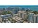 An aerial view showcases a high-rise condo building with views of the harbor and city skyline at 750 N Tamiami Trl # 304, Sarasota, FL 34236