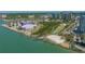 An aerial view of the Sarasota coastline with a highlighted waterfront condo in the background at 750 N Tamiami Trl # 304, Sarasota, FL 34236