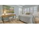 Light and airy bedroom with plantation shutters and a decorative wooden desk at 750 N Tamiami Trl # 304, Sarasota, FL 34236