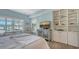 Bright bedroom featuring built-in shelves, plantation shutters, and light wood flooring at 750 N Tamiami Trl # 304, Sarasota, FL 34236