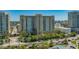 Exterior view of high-rise condo building with manicured landscaping and street view at 750 N Tamiami Trl # 304, Sarasota, FL 34236