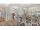 Open concept dining area with a glass table, view of the kitchen, and light wood flooring at 750 N Tamiami Trl # 304, Sarasota, FL 34236