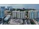 An exterior aerial view of the condo featuring a covered parking area and balconies at 750 N Tamiami Trl # 304, Sarasota, FL 34236