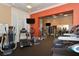Community fitness center with multiple treadmills, ellipticals, and televisions at 750 N Tamiami Trl # 304, Sarasota, FL 34236
