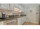 Updated kitchen area with stainless steel appliances, granite countertops, and white cabinetry at 750 N Tamiami Trl # 304, Sarasota, FL 34236
