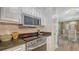 Kitchen featuring stainless steel appliances, granite countertops, and a view to dining room at 750 N Tamiami Trl # 304, Sarasota, FL 34236