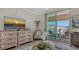 Cozy living room featuring an ornate dresser, comfortable seating, and sliding doors to a balcony at 750 N Tamiami Trl # 304, Sarasota, FL 34236