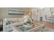 Comfortable living room with stylish decor, including a plush sofa and modern lighting fixtures at 750 N Tamiami Trl # 304, Sarasota, FL 34236