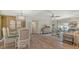 Living space featuring dining table, wooden floors, and natural light at 750 N Tamiami Trl # 304, Sarasota, FL 34236