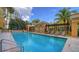 Inviting outdoor pool offering clear turquoise water, and convenient poolside lounging and umbrellas at 750 N Tamiami Trl # 304, Sarasota, FL 34236