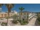 Exterior view of the community featuring well maintained sidewalks and tropical landscaping at 750 N Tamiami Trl # 304, Sarasota, FL 34236