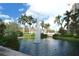 Scenic water feature with palm trees and lush greenery creating a tranquil atmosphere at 750 N Tamiami Trl # 304, Sarasota, FL 34236