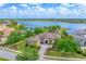 Stunning aerial view of a lakefront home with lush landscaping and a tile roof at 7643 Haddington Cv, Bradenton, FL 34202