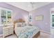 Bright, light-filled bedroom with shuttered windows, wicker accents, and soothing decor at 7643 Haddington Cv, Bradenton, FL 34202